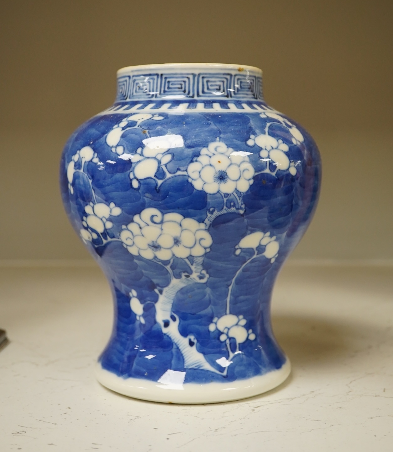 A 19th century Chinese blue and white 'prunus' vase, a Chinese green glazed jar, a Japanese vase and two dishes and two Canton famille rose plates (7). Condition - fair to good